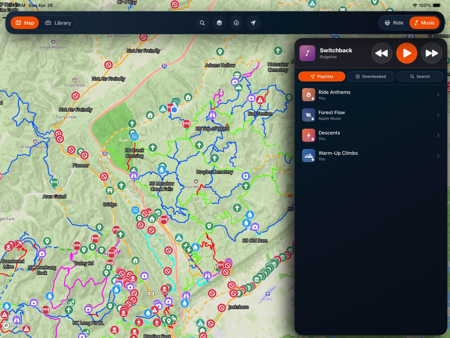 Music panel with offline playlists and playback controls beside the trail map