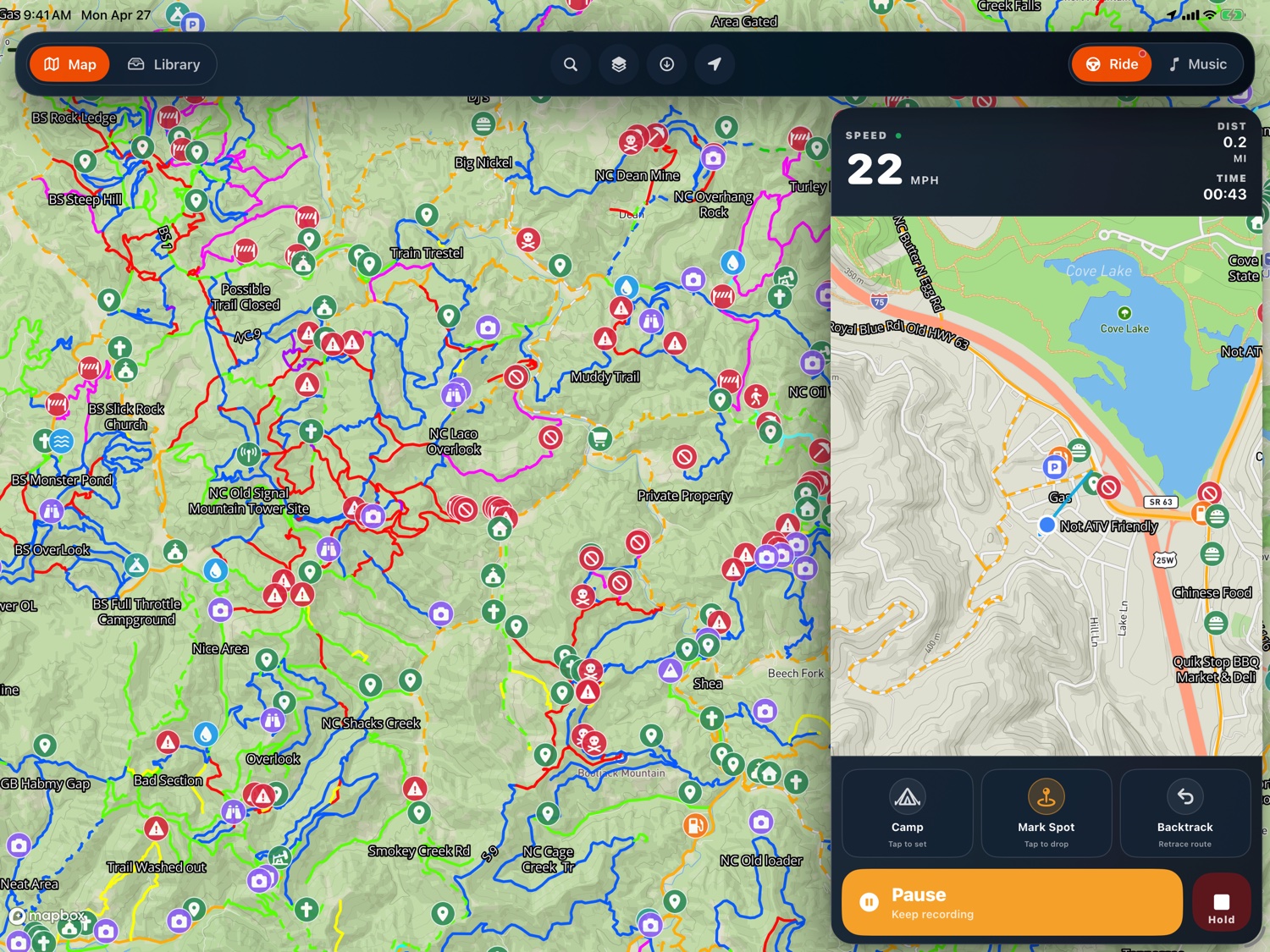 Ride dashboard on iPad with live speed, distance, ride time, mini-map, and one-tap Camp / Mark Spot / Backtrack tiles